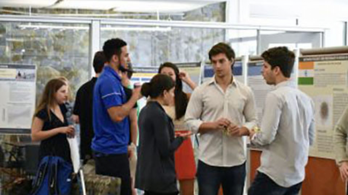 Students standing at poster presentation