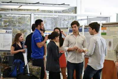 Students standing at poster presentation